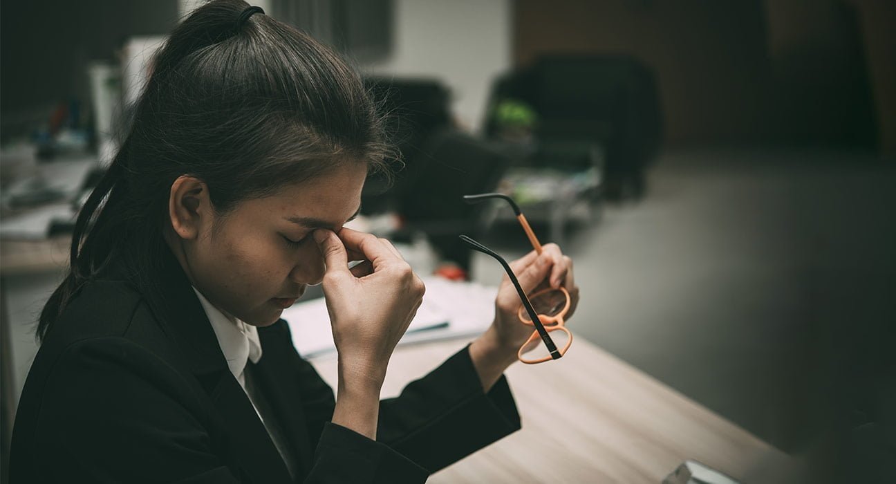 a employee siting stressed in the workplace