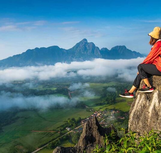 A girl sitting on hills and enjoying the view